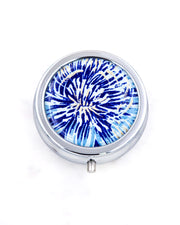 Silver metal pill box featuring a blue and gold chrysanthemum.