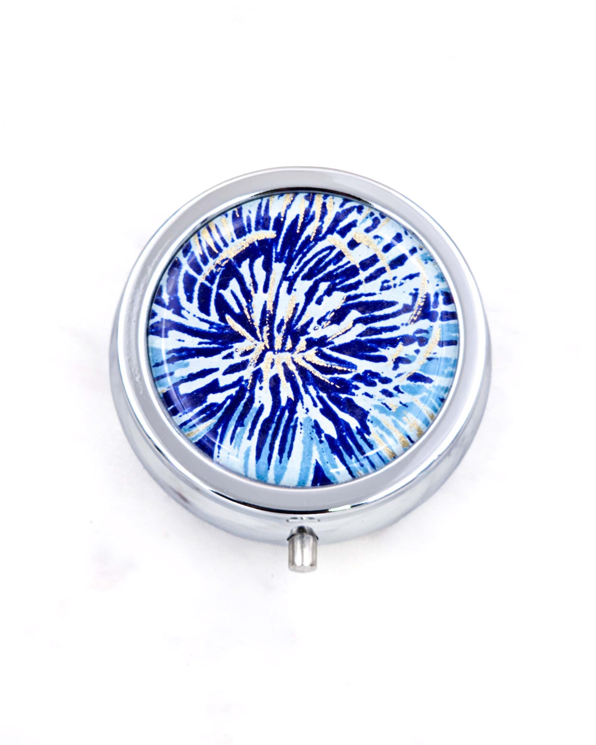 Silver metal pill box featuring a blue and gold chrysanthemum.