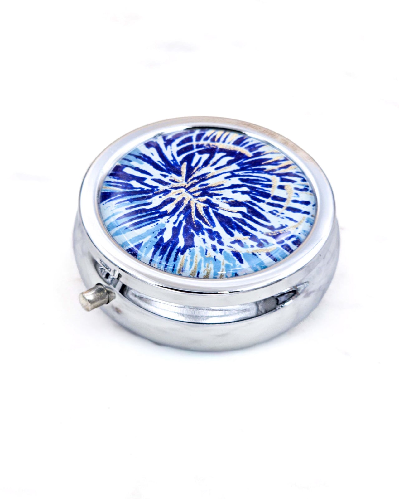 Silver metal pill box featuring a blue and gold chrysanthemum.