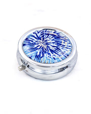 Silver metal pill box featuring a blue and gold chrysanthemum.