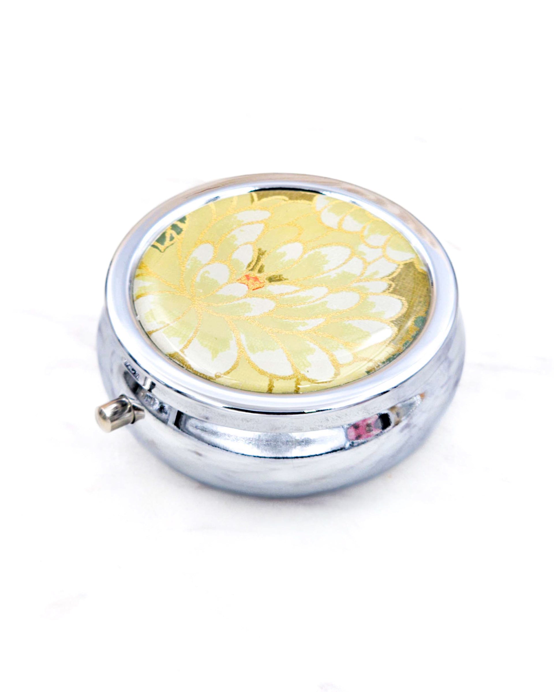 Silver metal pill box featuring a yellow chrysanthemum with metallic gold accents.