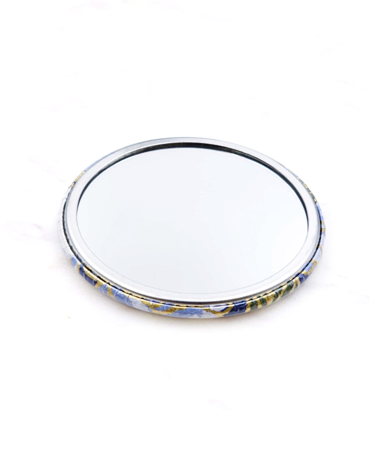 Round pocket mirror featuring a blue chrysanthemum flower with metallic gold accents.