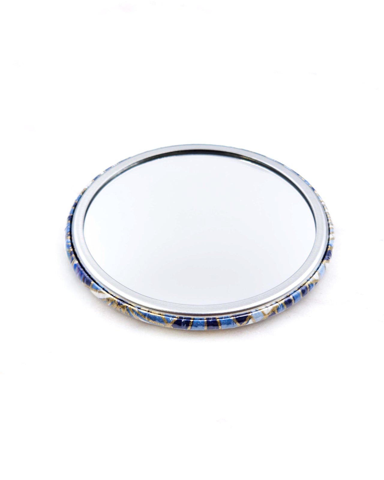 Round pocket mirror featuring blue and white abstract parasols with metallic gold accents.