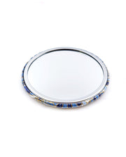 Round pocket mirror featuring blue and white abstract parasols with metallic gold accents.