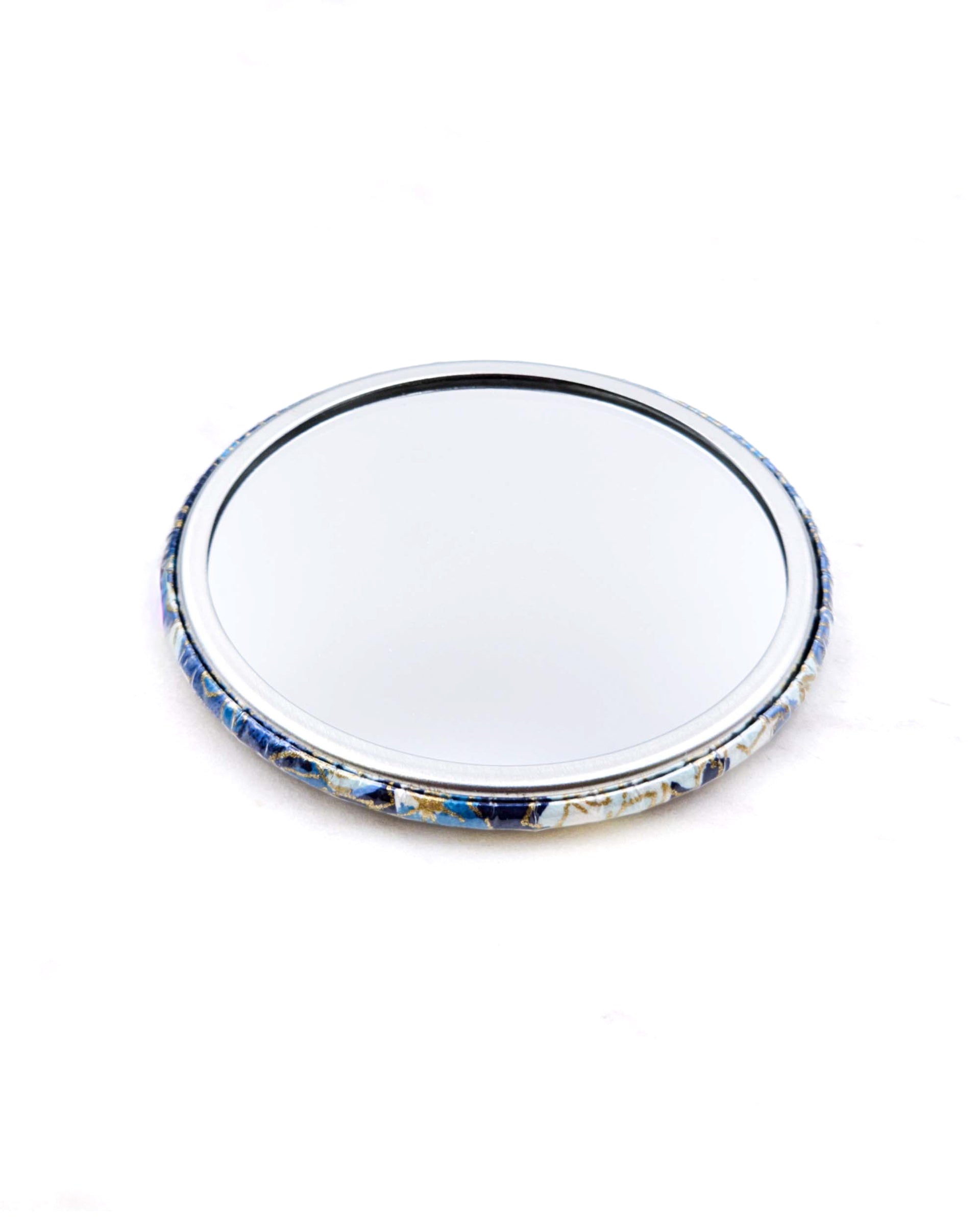 Round pocket mirror featuring blue and white cherry blossoms and maple leaves on a blue and white background with metallic gold accents.