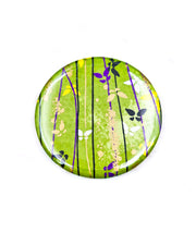 Round pocket mirror featuring small butterflies on a green background with metallic gold accents.