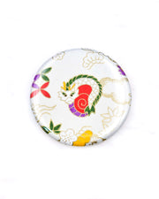 Round pocket mirror featuring a cute red, green, and white dragon on a white background with metallic gold accents.