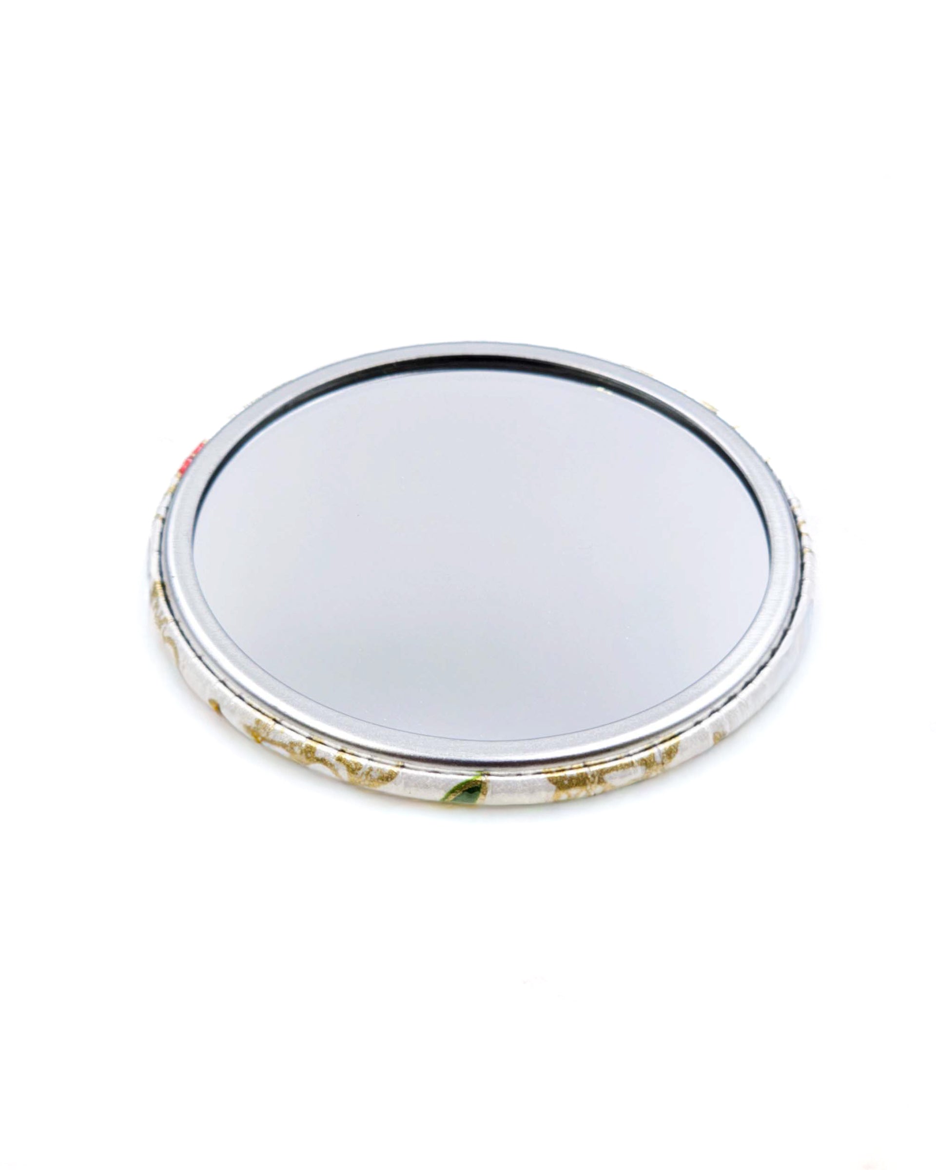 Round pocket mirror featuring a cute red, green, and white dragon on a white background with metallic gold accents.