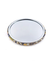 Round pocket mirror featuring pink, yellow, and green daffodil flowers on a gray background with metallic gold accents.