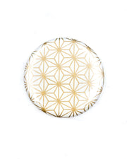 Round pocket mirror featuring a traditional gold asanoha (hemp leaf) design on a white background.