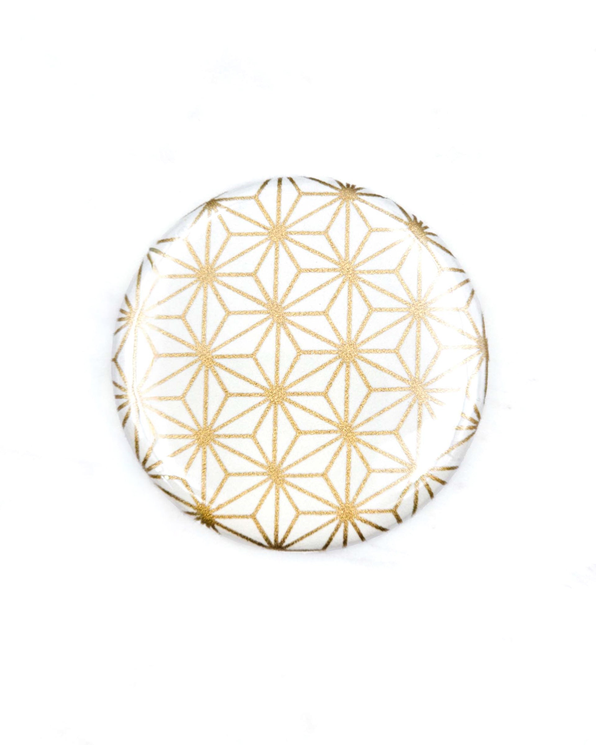 Round pocket mirror featuring a traditional gold asanoha (hemp leaf) design on a white background.