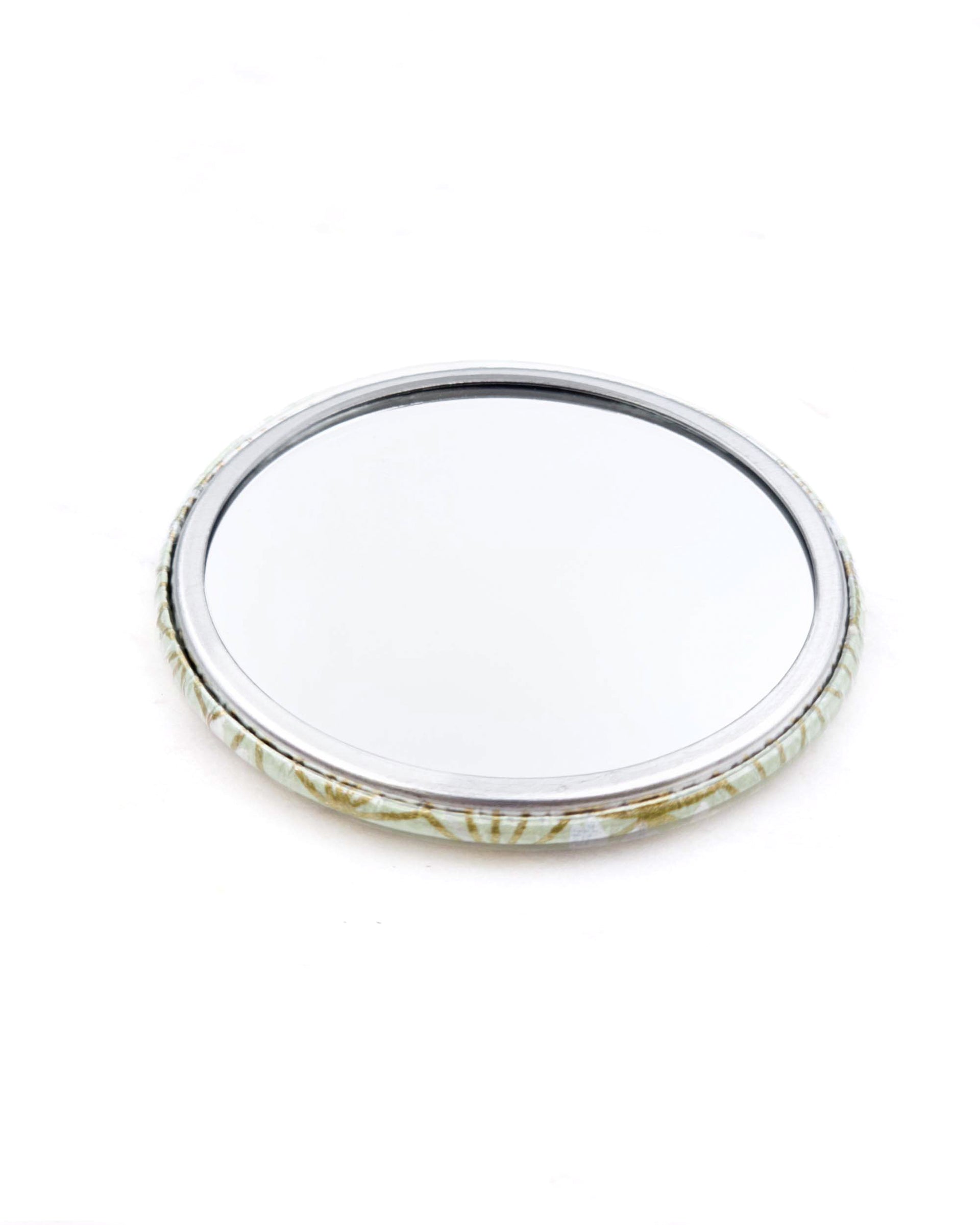 Round pocket mirror featuring a traditional gold asanoha (hemp leaf) design on a white background.