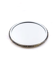 Round pocket mirror featuring metallic gold waves on a black background.