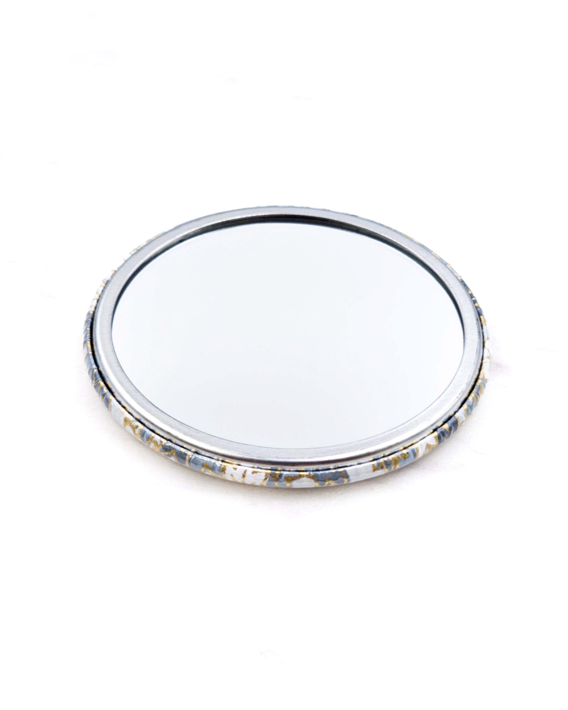 Round pocket mirror featuring gray and white maple leaves with metallic gold accents.