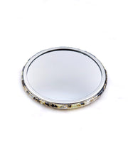 Round pocket mirror featuring gray and white cherry blossoms and other flowers on a gray and white background with metallic gold accents.