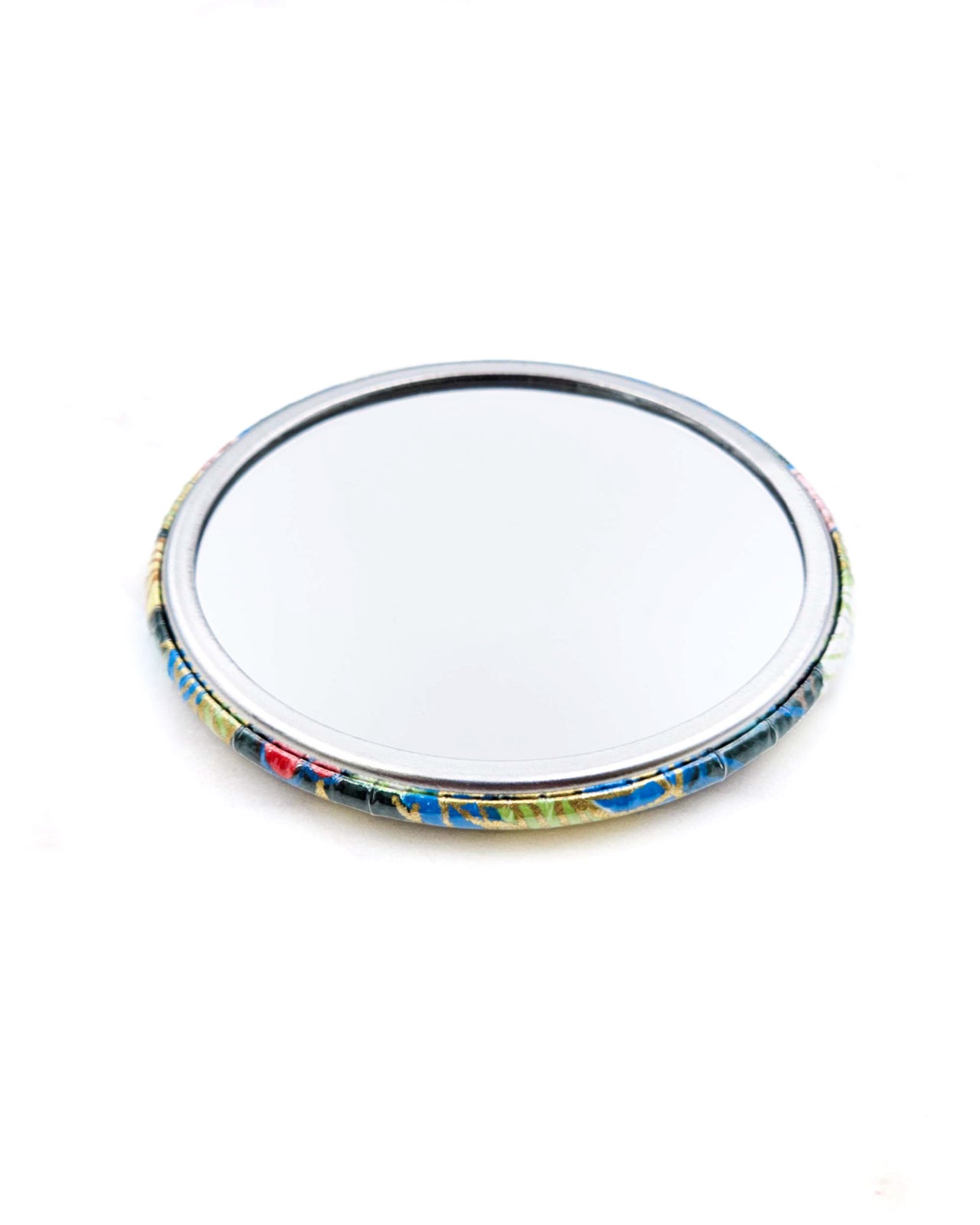 Round pocket mirror featuring yellow, blue, and green leaves and persimmons on a green background with metallic gold accents.