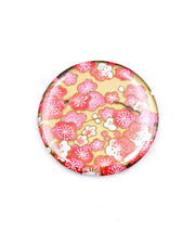 Round pocket mirror featuring pink plum blossoms on a metallic gold background.