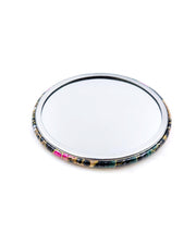 Round pocket mirror featuring pink and white plum blossoms on a black background with metallic gold accents.