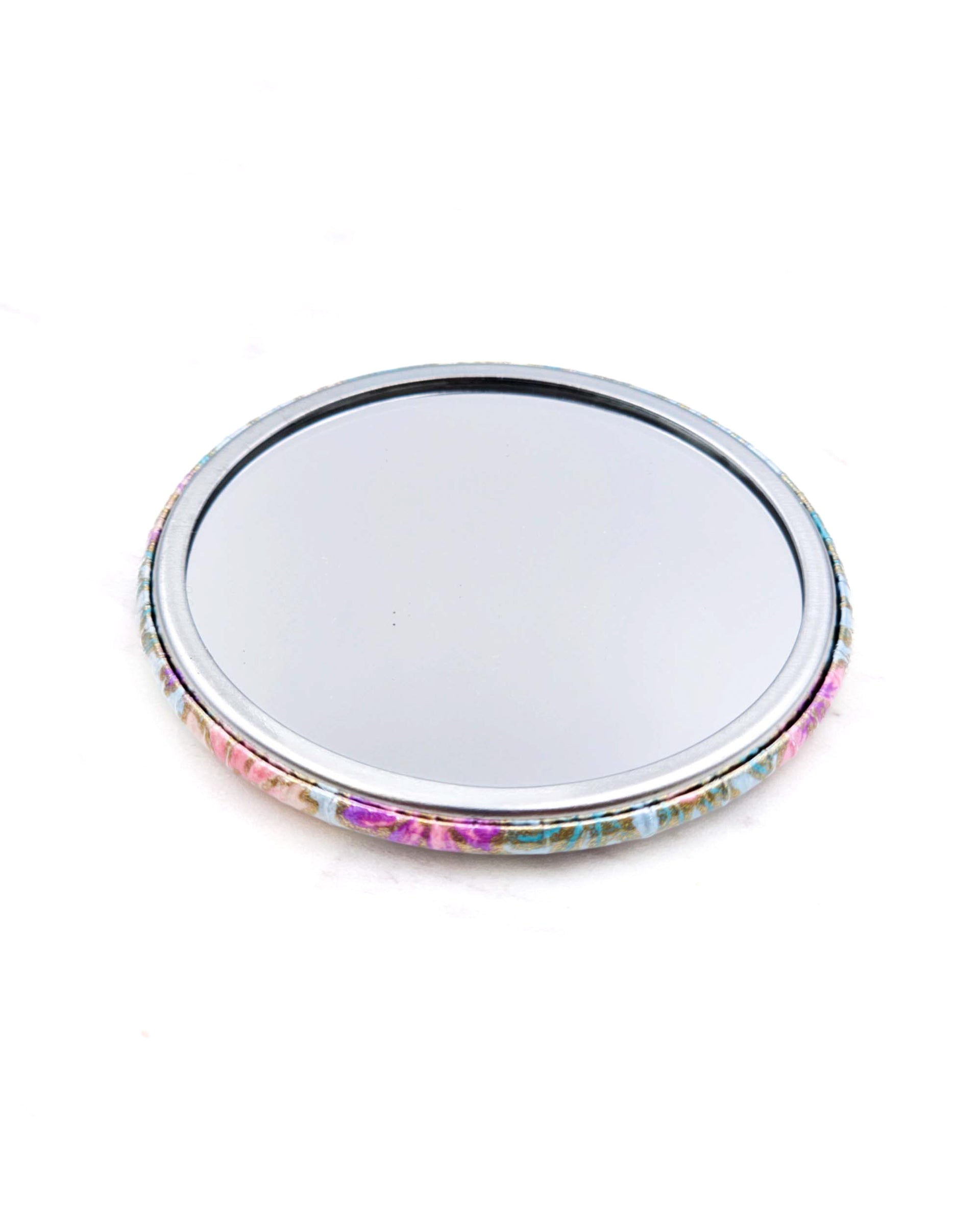 Round pocket mirror featuring yellow flower stalks on a light blue background with metallic gold accents.