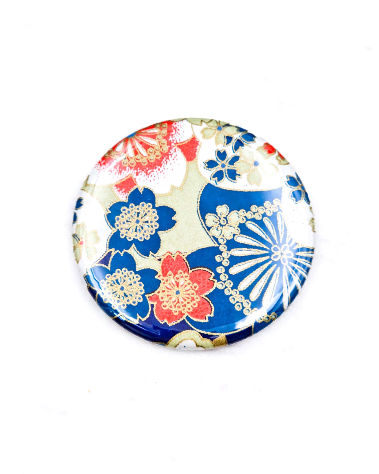 Round pocket mirror featuring red, blue, and white cherry blossoms with metallic gold accents.