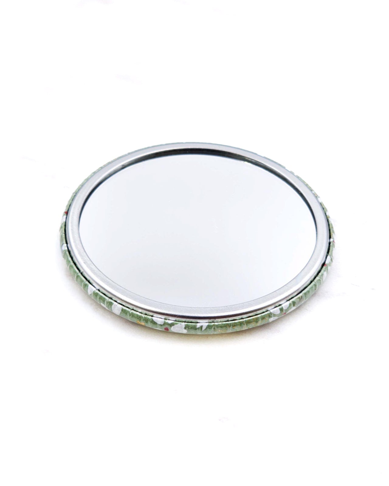 Round pocket mirror featuring small white and gold cherry blossoms on a light green background with metallic gold accents.