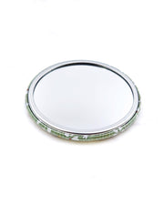 Round pocket mirror featuring small white and gold cherry blossoms on a light green background with metallic gold accents.