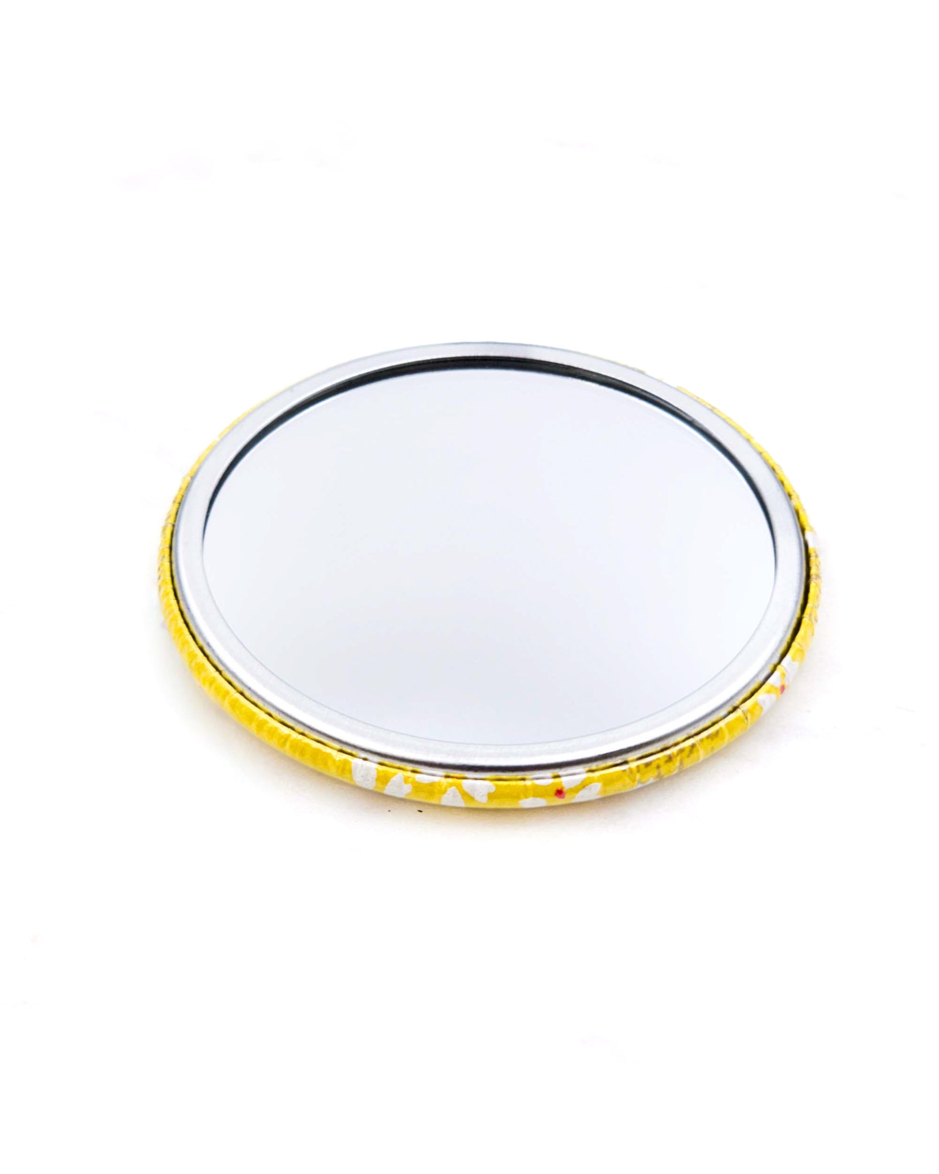 Round pocket mirror featuring small white and gold cherry blossoms on a yellow background with metallic gold accents.