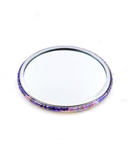 Round pocket mirror featuring yellow and purple flowers on a purple background with metallic gold accents.