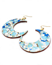 X-Large wooden Crescent Moon shaped earrings featuring turquoise blue and white plum blossom tree with dark brown branches on a blue background with metallic gold details.