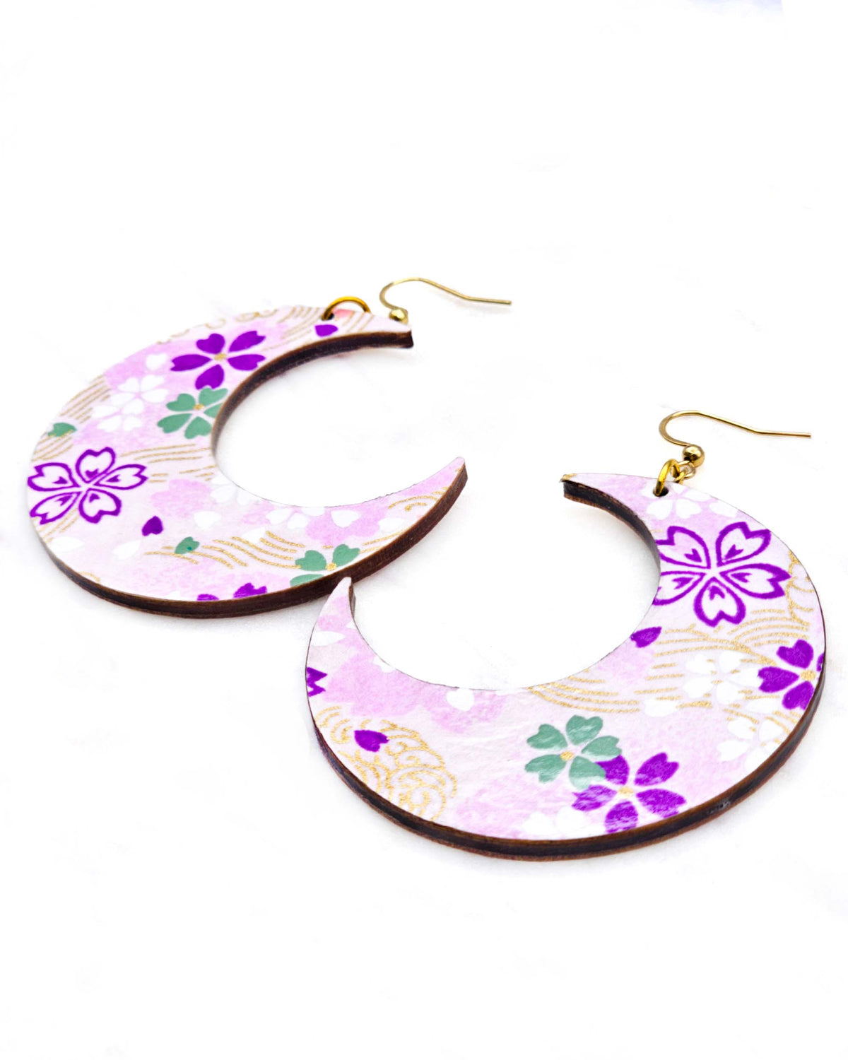 X-Large wooden Crescent Moon shaped earrings featuring purple, white, green, and pink cherry blossoms on a purple background with metallic gold details.
