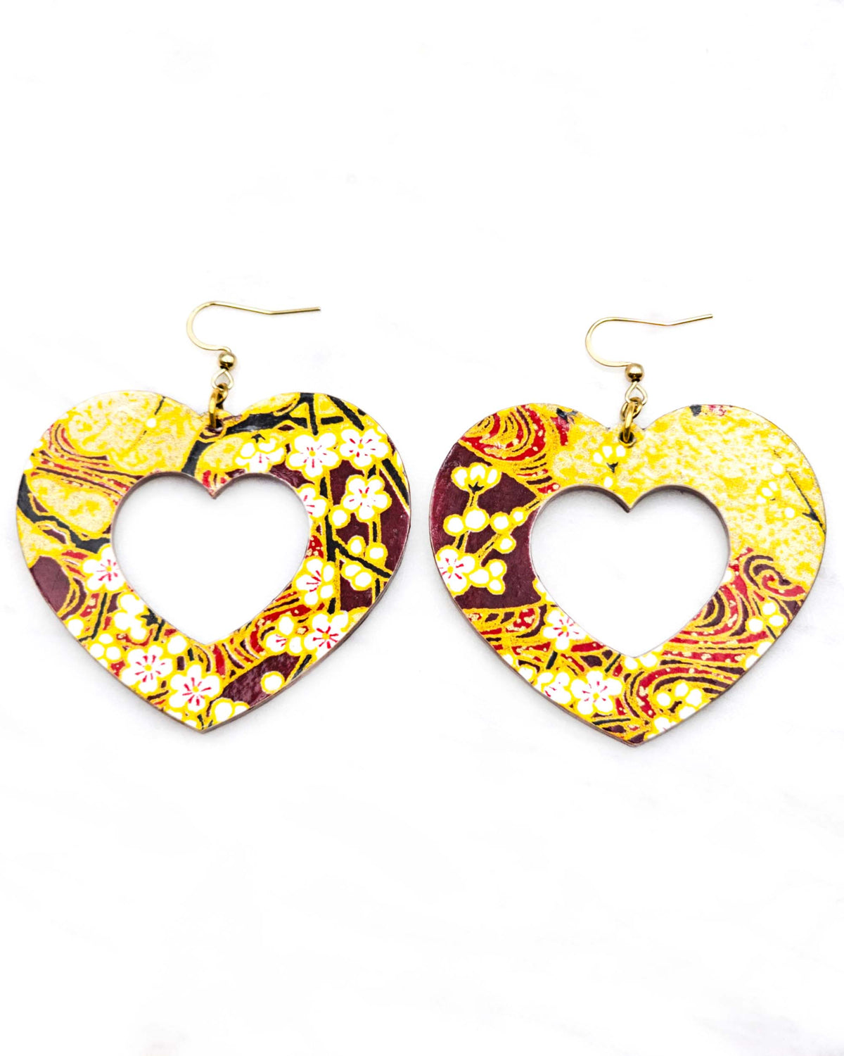 X-Large wooden hollow heart shaped earrings featuring white plum blossom branches on a maroon red and brown background with metallic gold details.