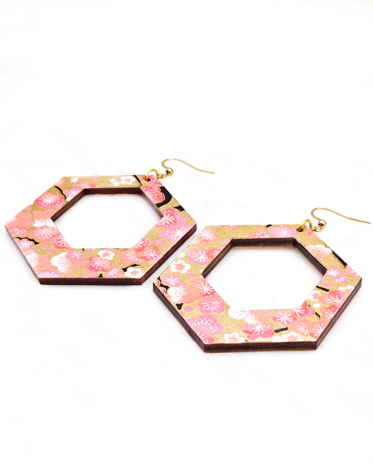 X-Large wooden hollow hexagon shaped earrings featuring pink and white plum blossoms with dark brown branches on a metallic gold background.