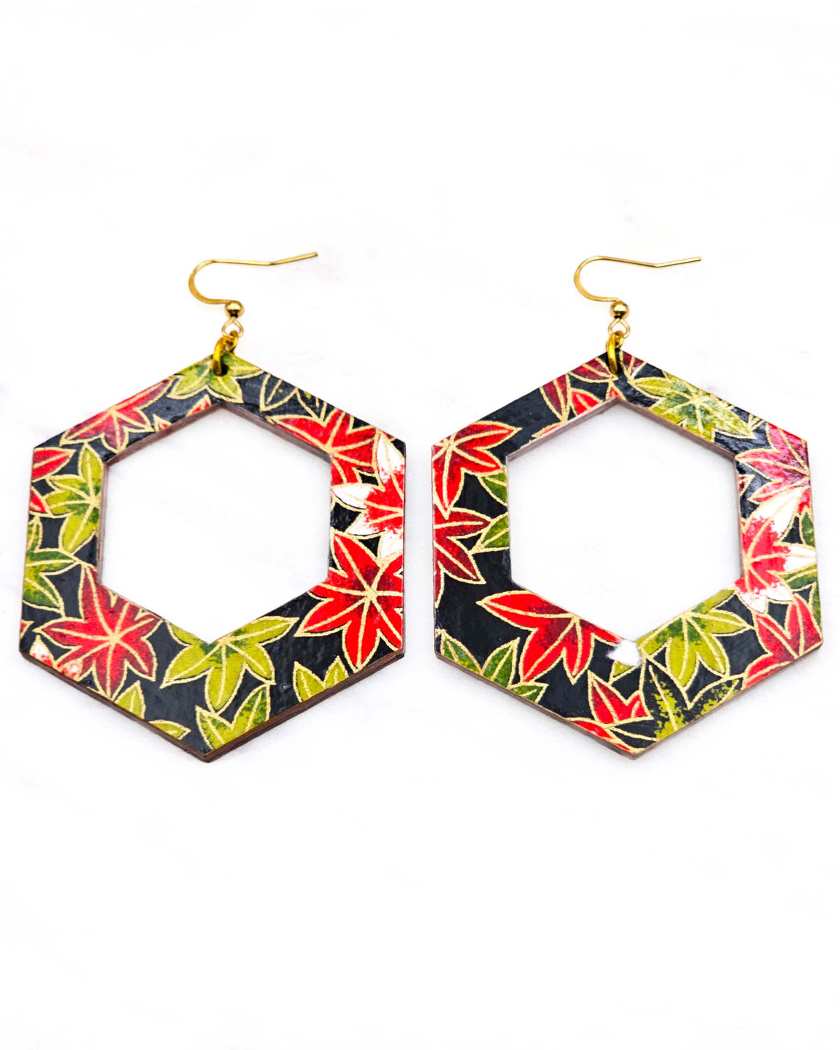 X-Large wooden hollow hexagon shaped earrings featuring red, green, and white maples leaves on a black background with metallic gold details.