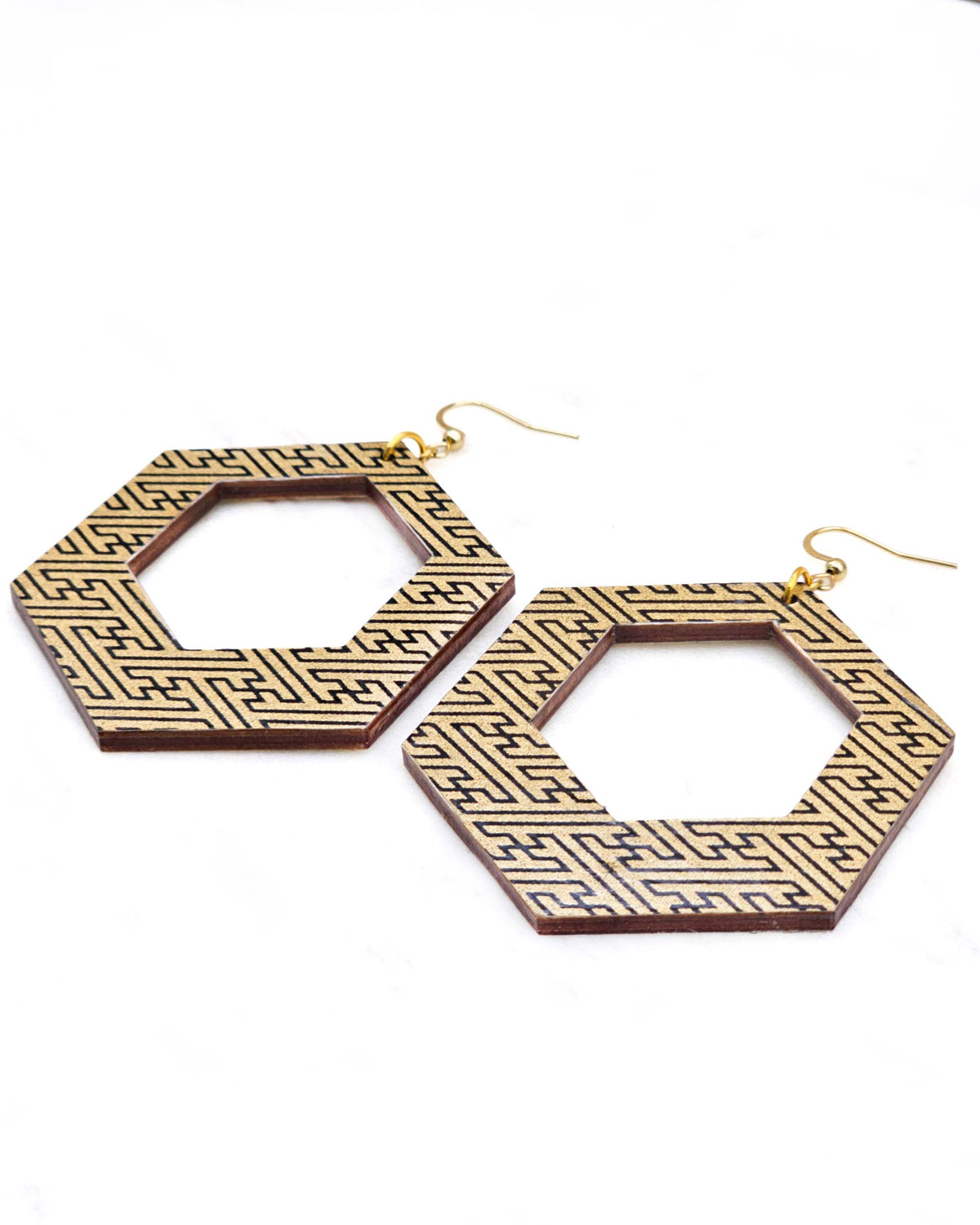 X-Large wooden hollow hexagon shaped earrings featuring a black sayagata design on a metallic gold background.