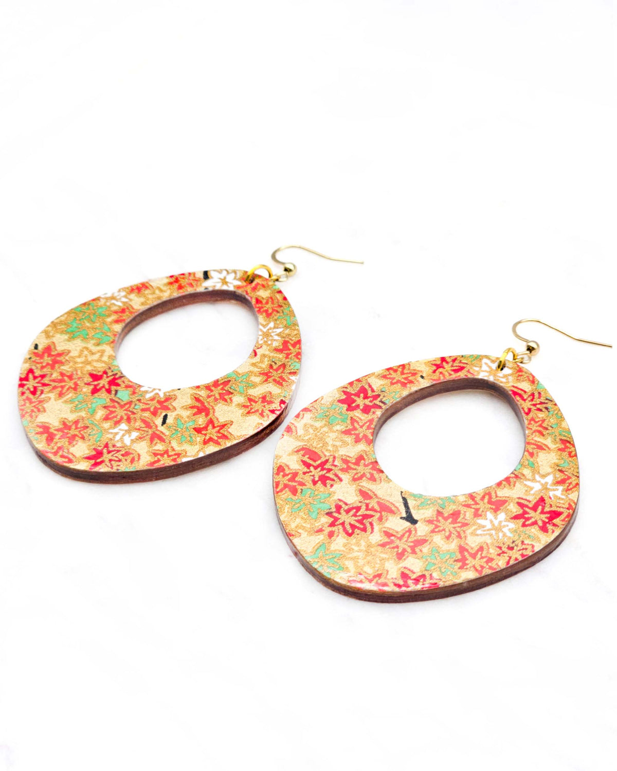 X-Large wooden abstract hoop shaped earrings featuring small red, green, and white momiji (maple leaves) on a gold background with metallic gold details.