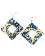 X-Large wooden hollow square diamond shaped earrings featuring metallic gold fibers in the style of traditional unryu paper on a dark blue background.