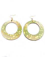 X-Large wooden round hoop shaped earrings featuring scattered metallic gold geometric shapes and fine gold lines on a green background.