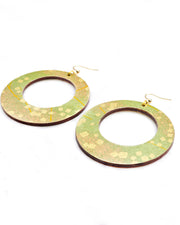 X-Large wooden round hoop shaped earrings featuring scattered metallic gold geometric shapes and fine gold lines on a green background.