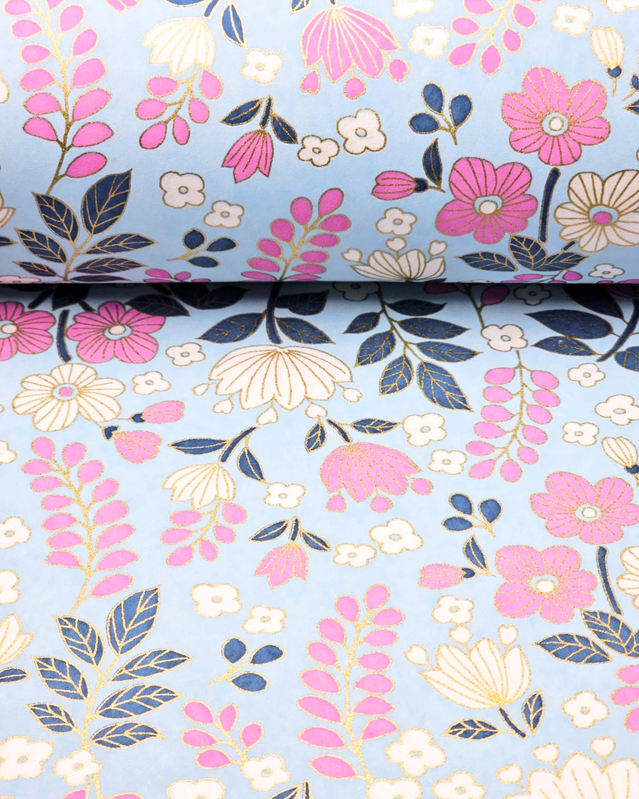 Japanese chiyogami paper featuring pink and white flowers with blue leaves and pink wisteria on a light blue background with metallic gold details.