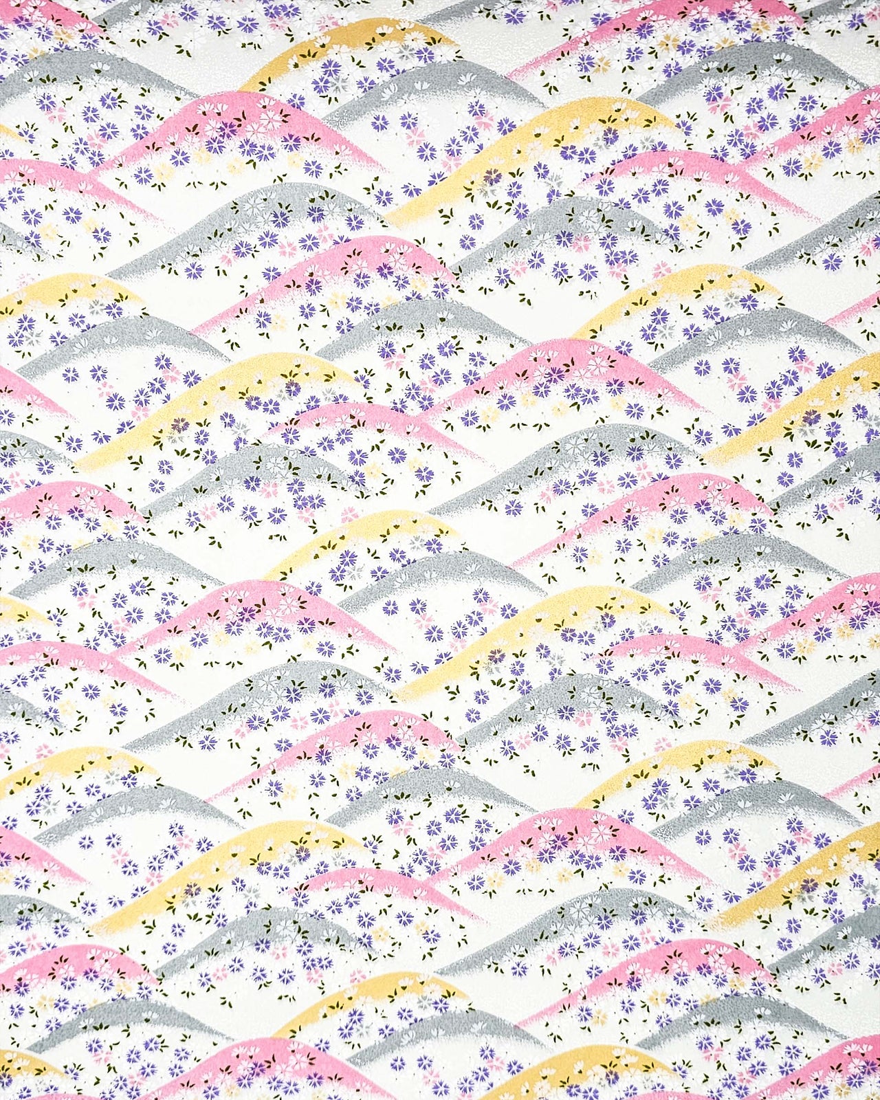 Japanese chiyogami paper featuring pink, gray, and gold hills with purple, pink, and white cherry blossoms on a white background with metallic gold details.