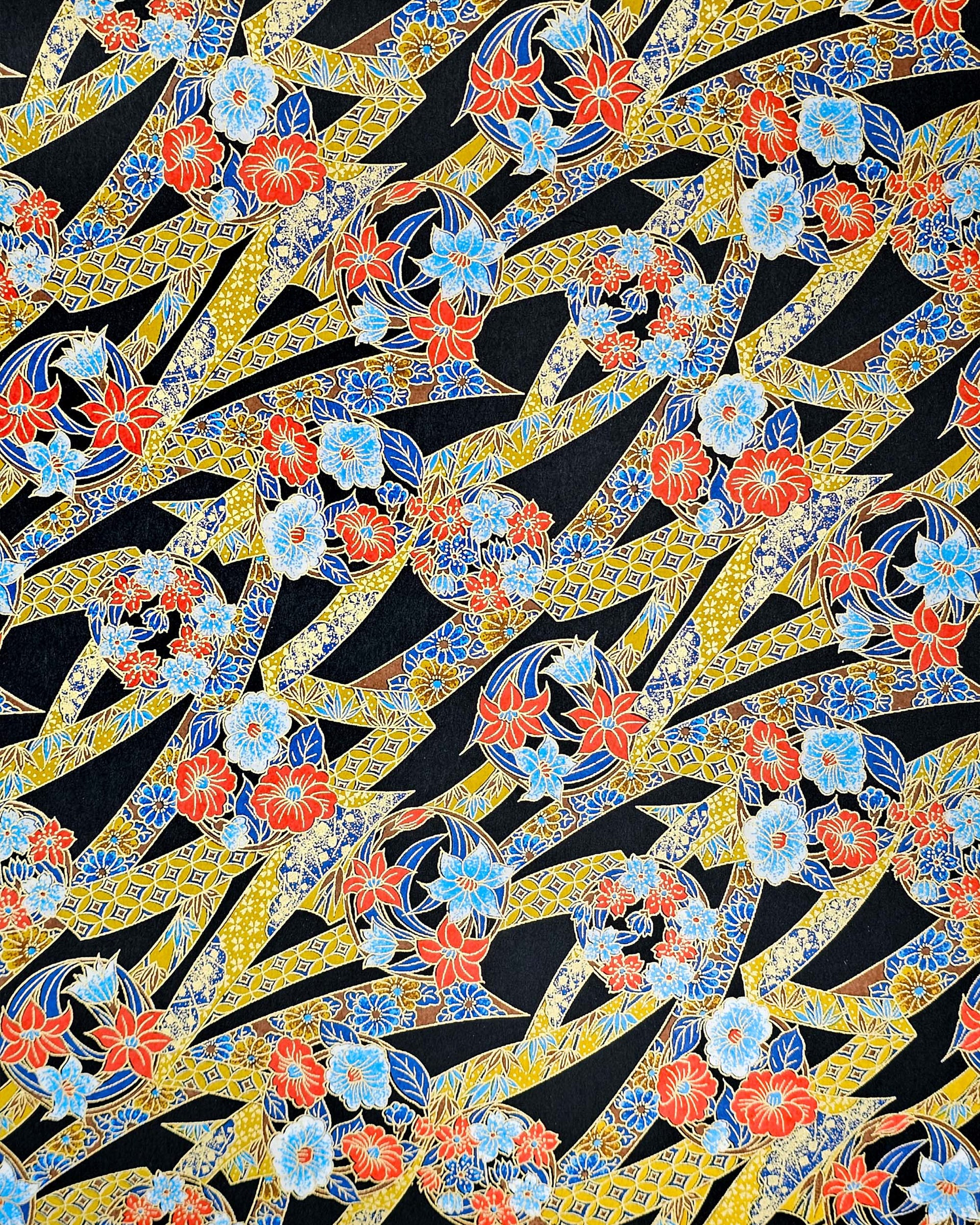 Japanese chiyogami paper featuring red and blue flowers intertwined in yellow and blue ribbons with a shippo floral pattern on a black background with metallic gold details.