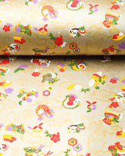 Japanese chiyogami paper featuring assorted white, purple, green, red, and yellow dragons on a gold background with metallic gold details.