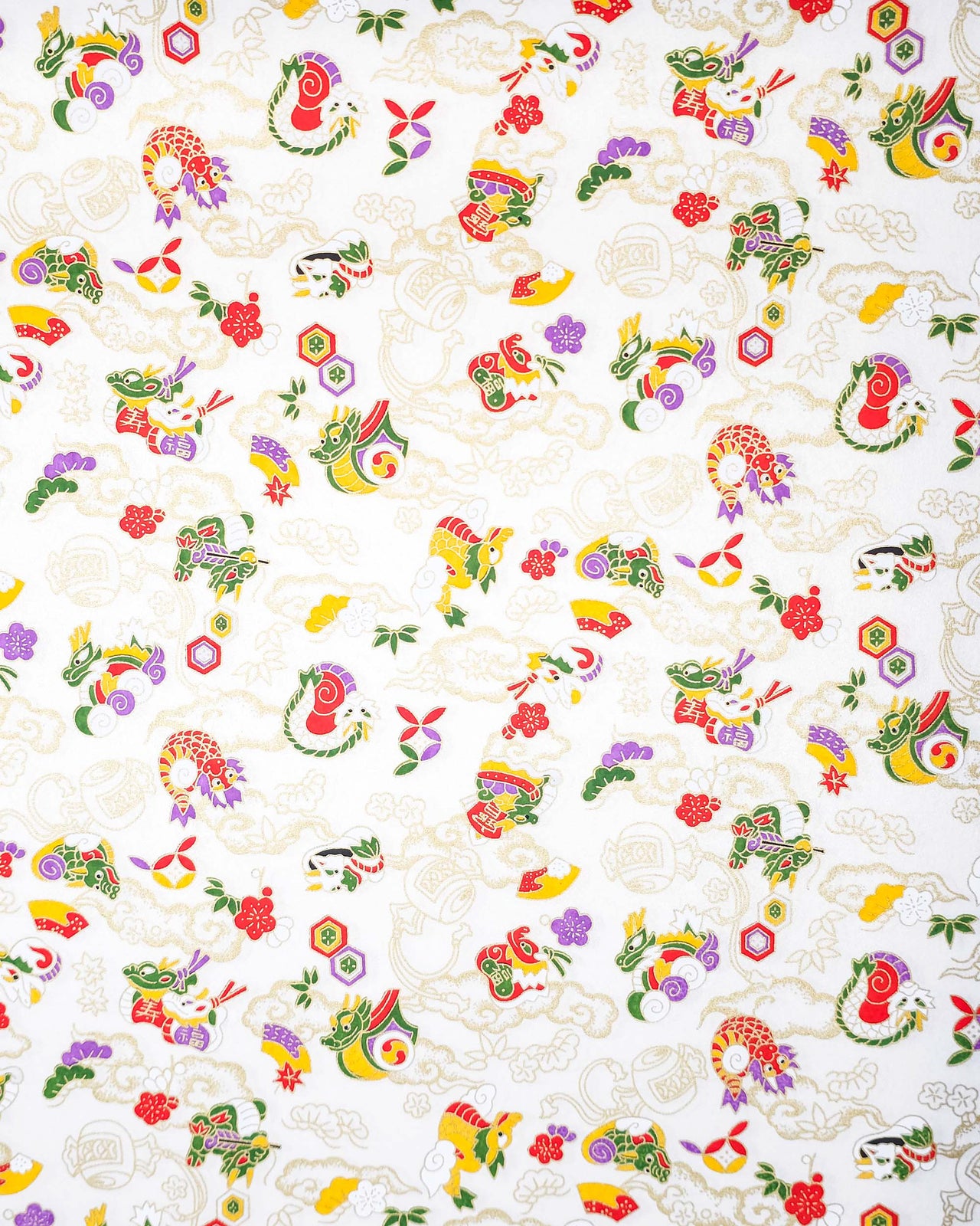 Japanese chiyogami paper featuring assorted white, purple, green, red, and yellow dragons on a shimmering pearlescent white background with metallic gold details.