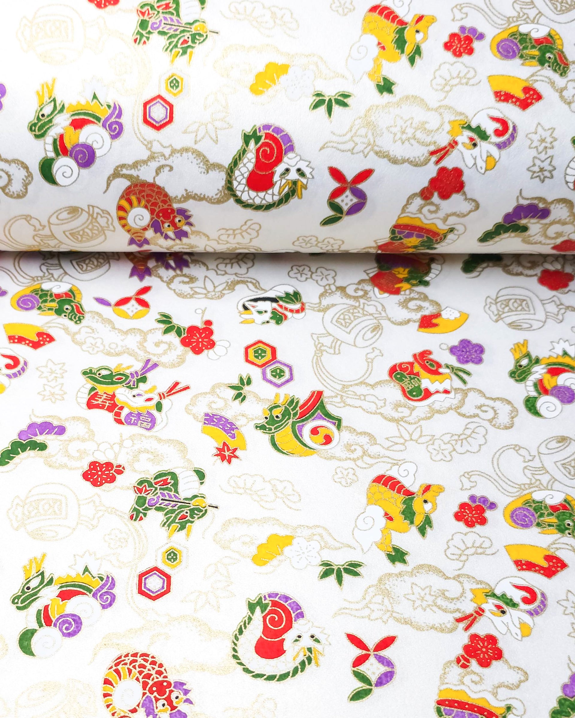 Japanese chiyogami paper featuring assorted white, purple, green, red, and yellow dragons on a shimmering pearlescent white background with metallic gold details.