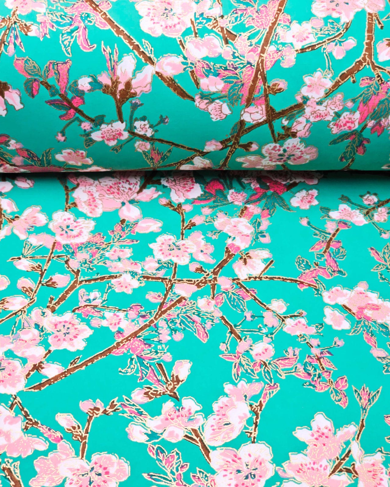 Japanese chiyogami paper featuring pink and white detailed plum blossoms with brown branches and green leaves on a turquoise background with metallic gold details.