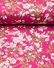Japanese chiyogami paper featuring pink and white detailed plum blossoms with brown branches and green leaves on a magenta pink background with metallic gold details.