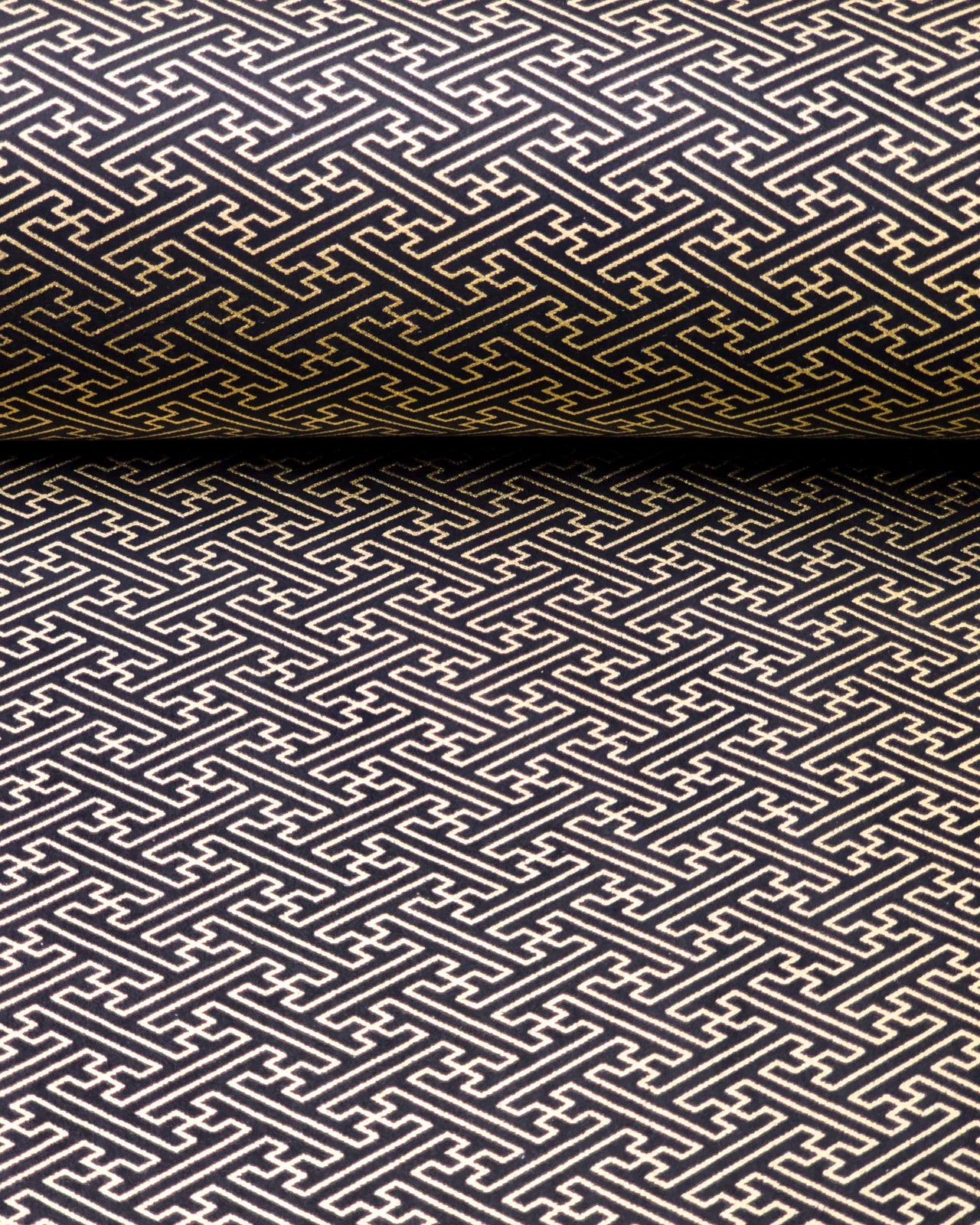 Japanese chiyogami paper featuring a metallic gold traditional Japanese sayagata design on a black background.