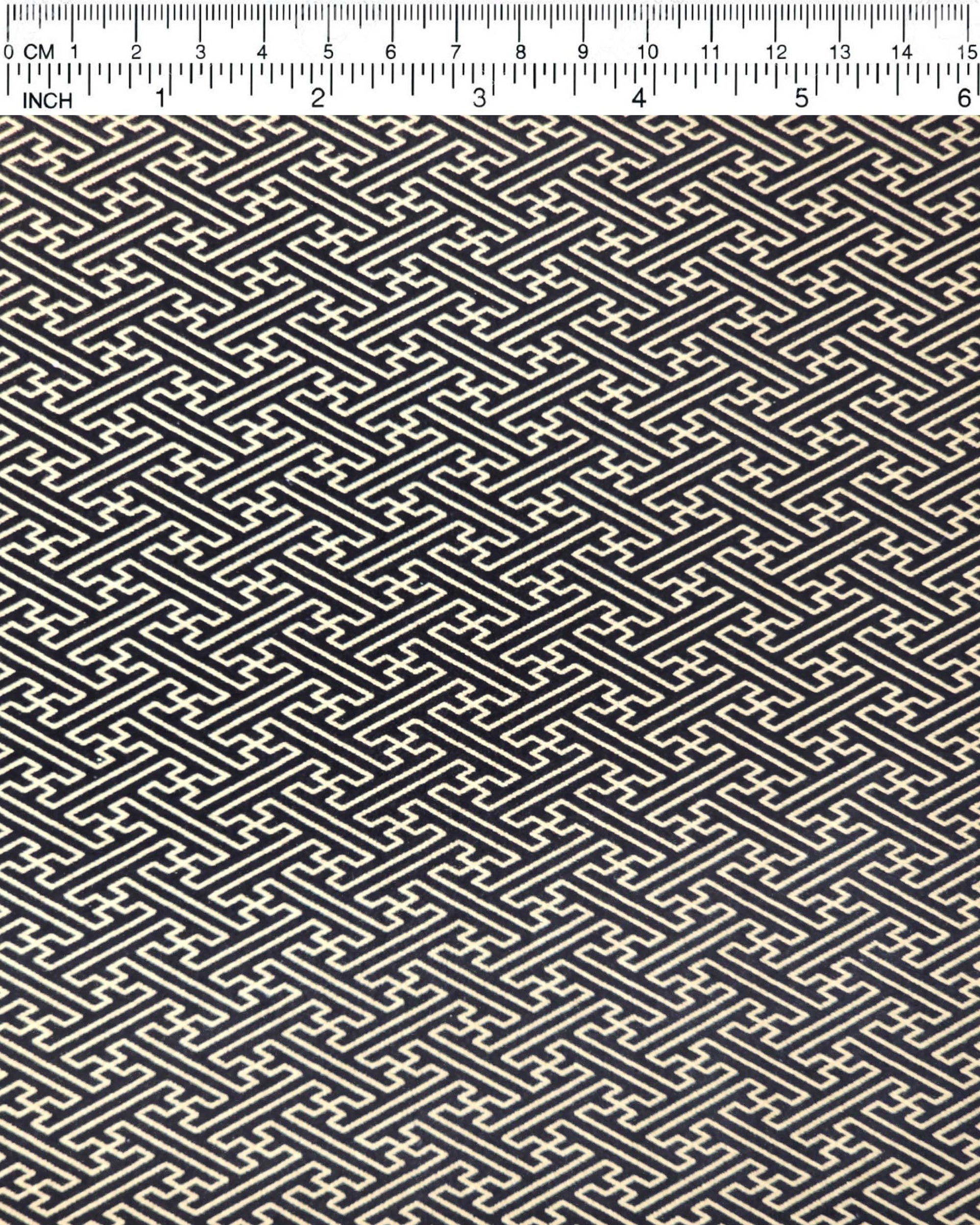 Japanese chiyogami paper featuring a metallic gold traditional Japanese sayagata design on a black background.
