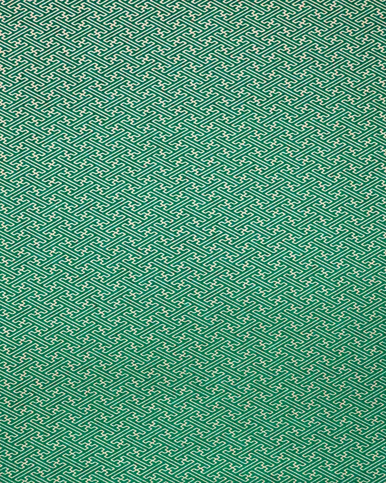 Japanese chiyogami paper featuring a small metallic gold traditional Japanese sayagata design on a green background.