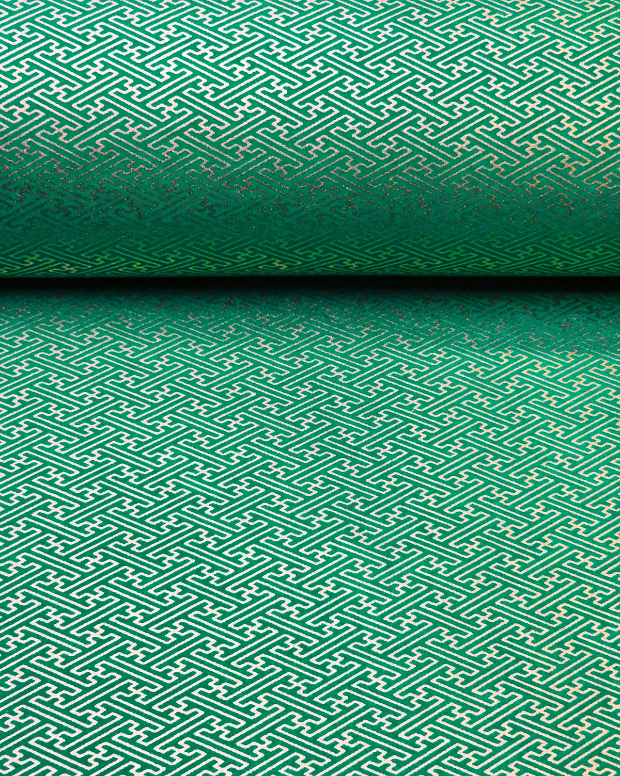 Japanese chiyogami paper featuring a small metallic gold traditional Japanese sayagata design on a green background.